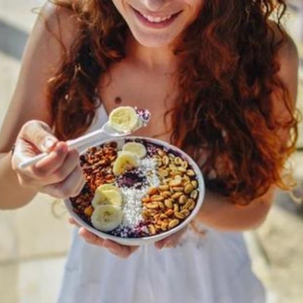 woman eating a smoothie bowl