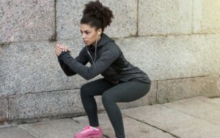Young woman doing bodyweight squat