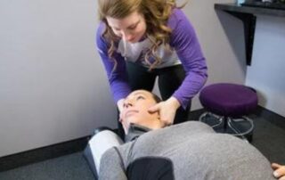 chiropractor adjusting womans neck
