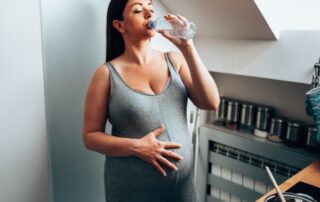 Pregnant woman drinking water with salt.