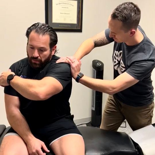 Male patient getting ART administered by male Doctor of Chiropractic.
