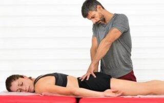 Male massage therapist releasing Piriformis Syndrome pain.