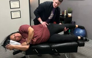 chiropractor doing an assessment during their first chiropractic visit.