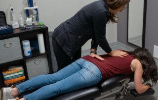 female chiropractor adjusting female patient.