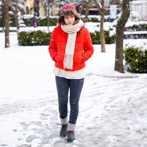 caucasian woman bundled up for an icy winter walk