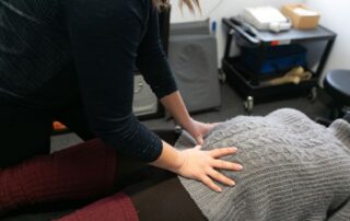 Female chiropractor treating a pregnant patient.