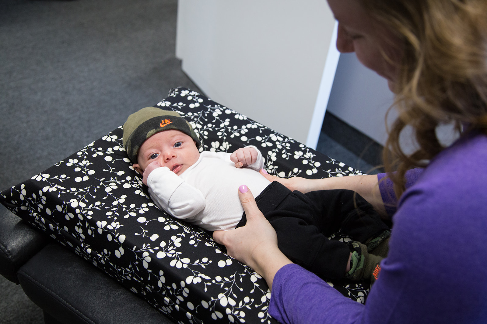 female chiropractor caring for infant.