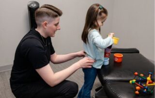 Chiropractor providing care for a little girl.