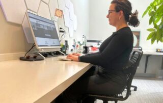 female employee sitting at a desk working on a computer